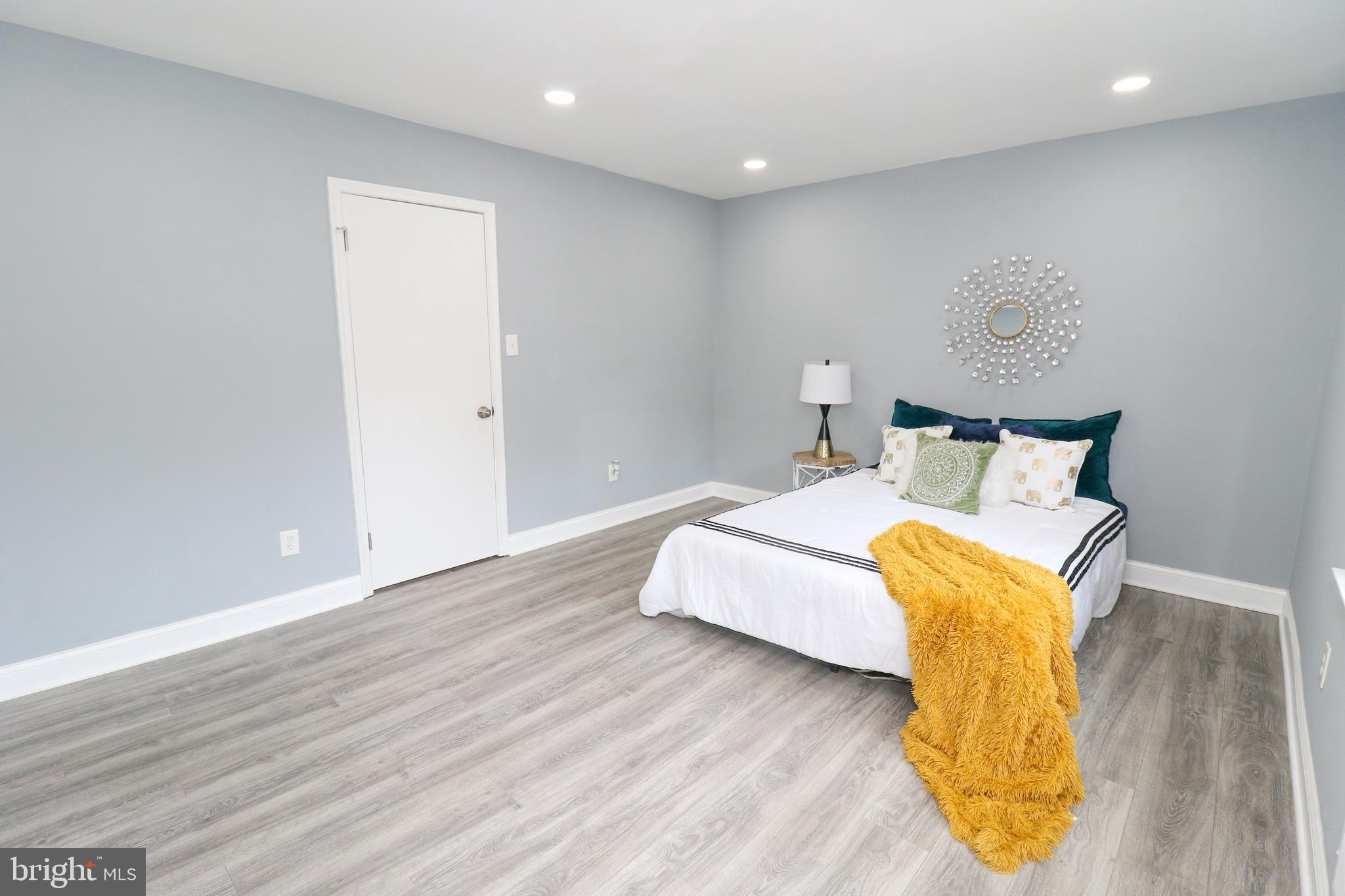 2309 Ravensdon Court Reston, VA 20191 - Photo 64 of 76 a bedroom with a bed and wooden floor