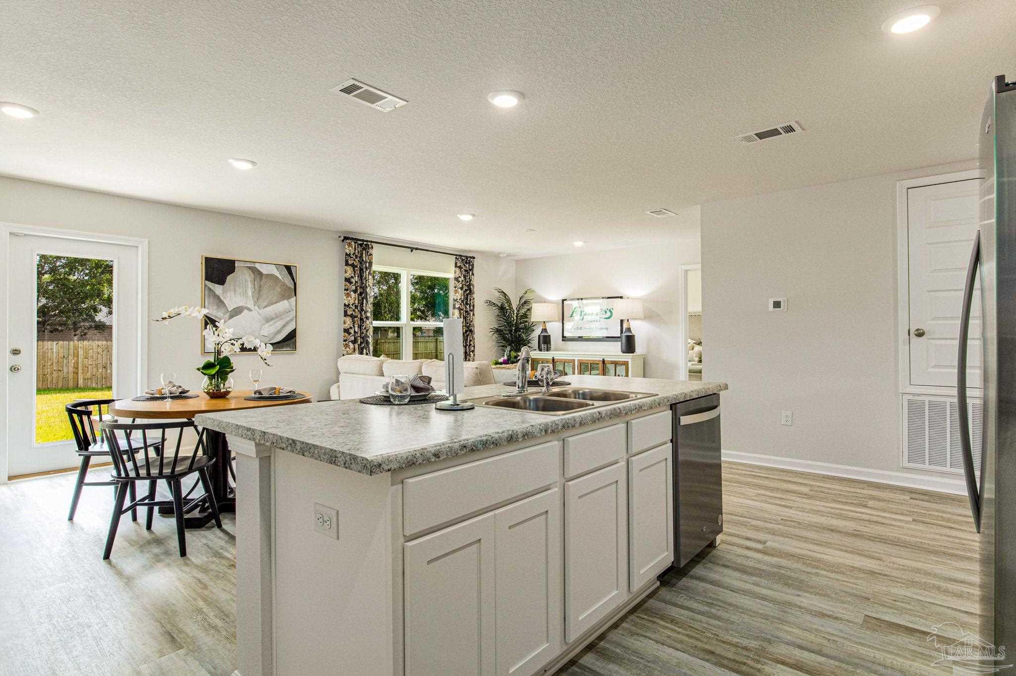 3312 Harrier Road Pace, FL 32571 - Photo 14 of 21 a kitchen with center island table and chairs