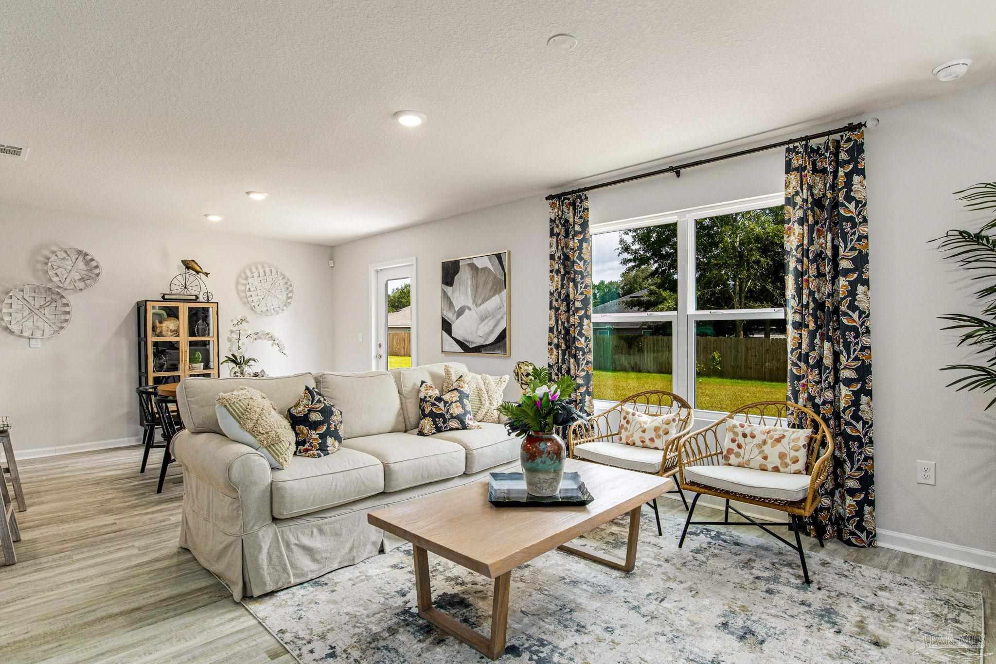 3312 Harrier Road Pace, FL 32571 - Photo 16 of 21 a living room with furniture and a large window