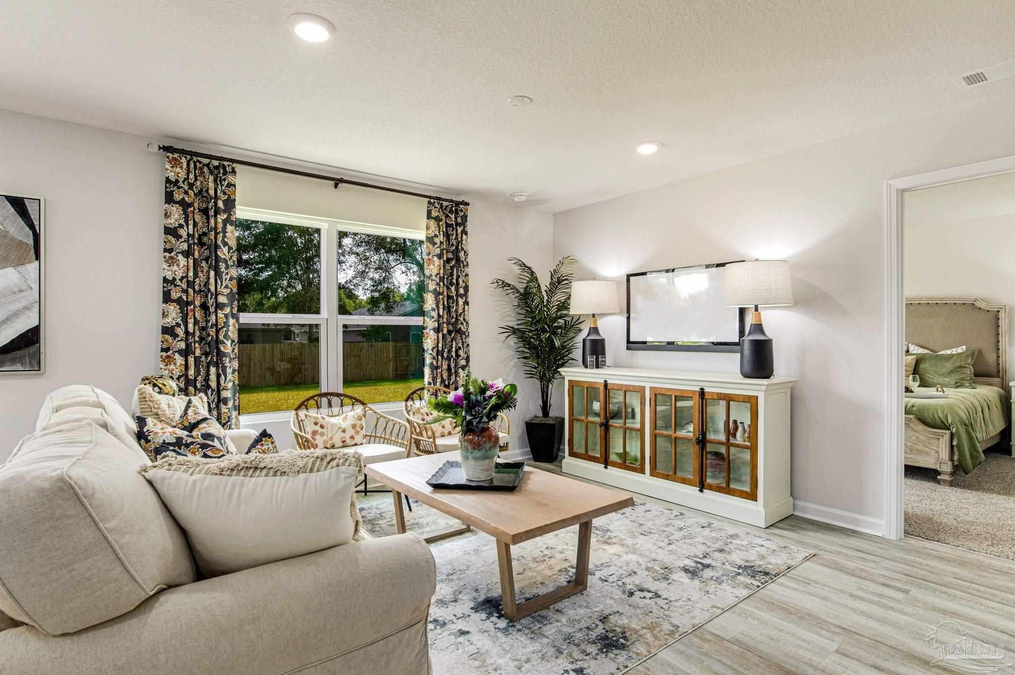 3312 Harrier Road Pace, FL 32571 - Photo 17 of 21 a living room with furniture and a large window