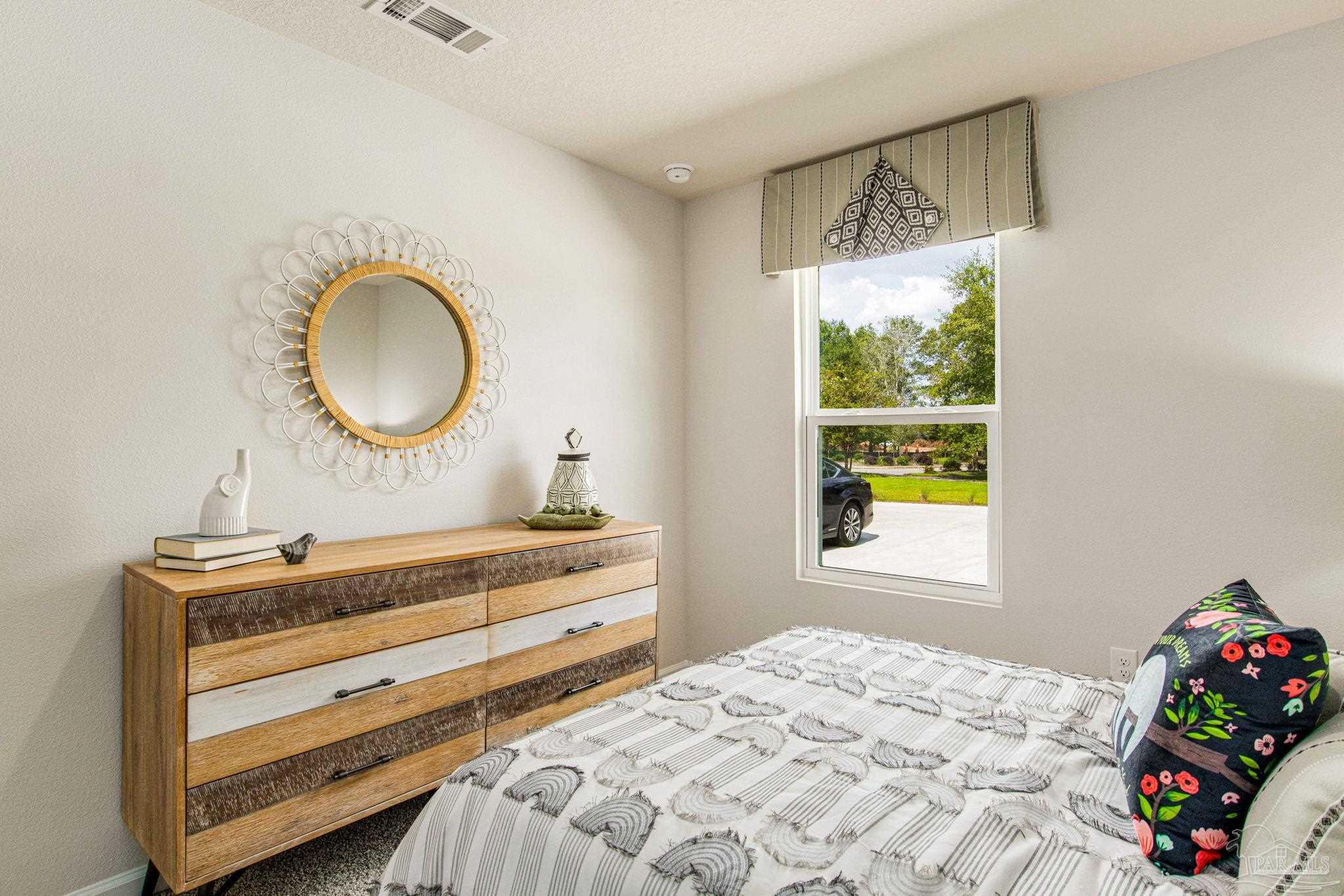 3312 Harrier Road Pace, FL 32571 - Photo 8 of 21 a bedroom with a bed and a window