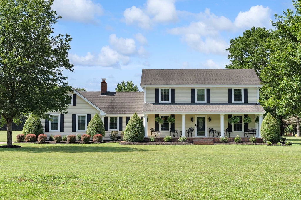 a front view of a house with a garden