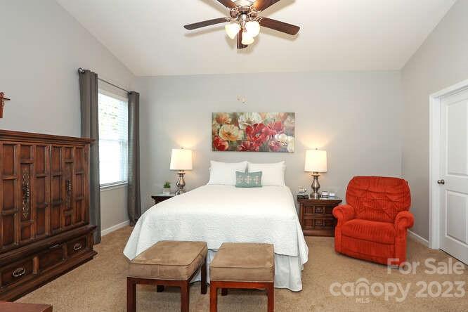 9728 Chase View Drive Matthews, NC 28105 - Photo 11 of 25 a bedroom with a bed and a chandelier