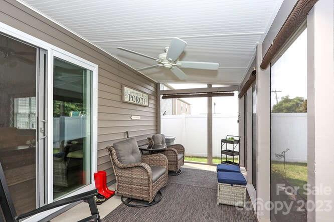 9728 Chase View Drive Matthews, NC 28105 - Photo 20 of 25 a living room with furniture a ceiling fan and a large window