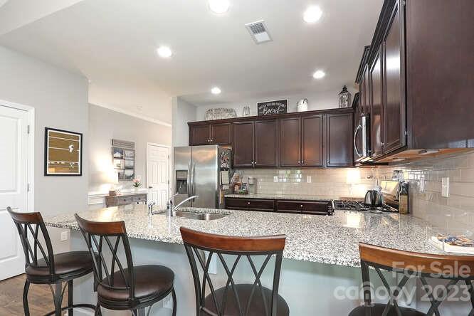 9728 Chase View Drive Matthews, NC 28105 - Photo 5 of 25 a kitchen with a dining table chairs and sink
