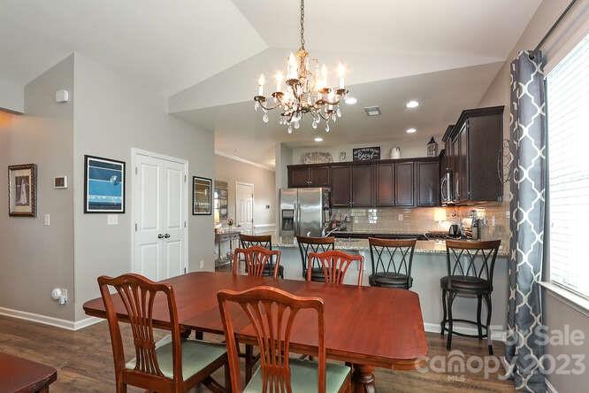 9728 Chase View Drive Matthews, NC 28105 - Photo 7 of 25 a view of a dining room with furniture and a chandelier