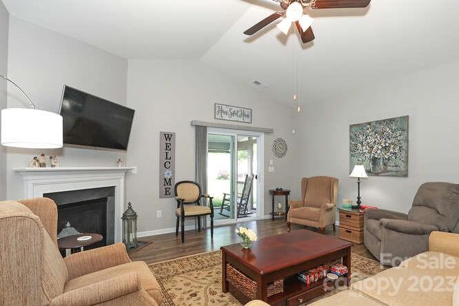 9728 Chase View Drive Matthews, NC 28105 - Photo 8 of 25 a living room with furniture a fireplace and a flat screen tv