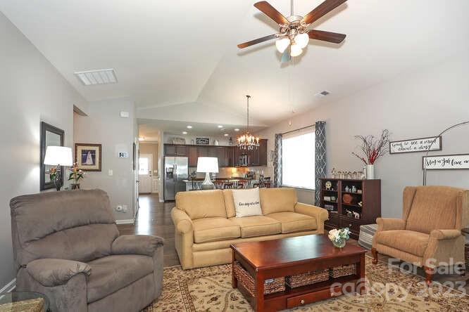 9728 Chase View Drive Matthews, NC 28105 - Photo 9 of 25 a living room with furniture a ceiling fan and a rug