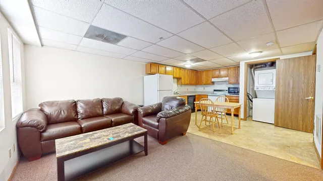 a living room with furniture a dining table and chairs