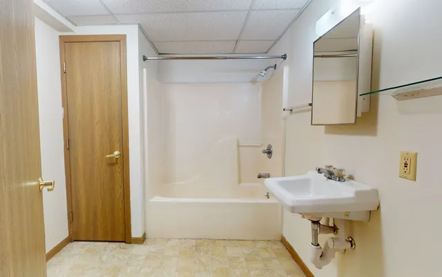 a bathroom with a sink a mirror and a bathtub