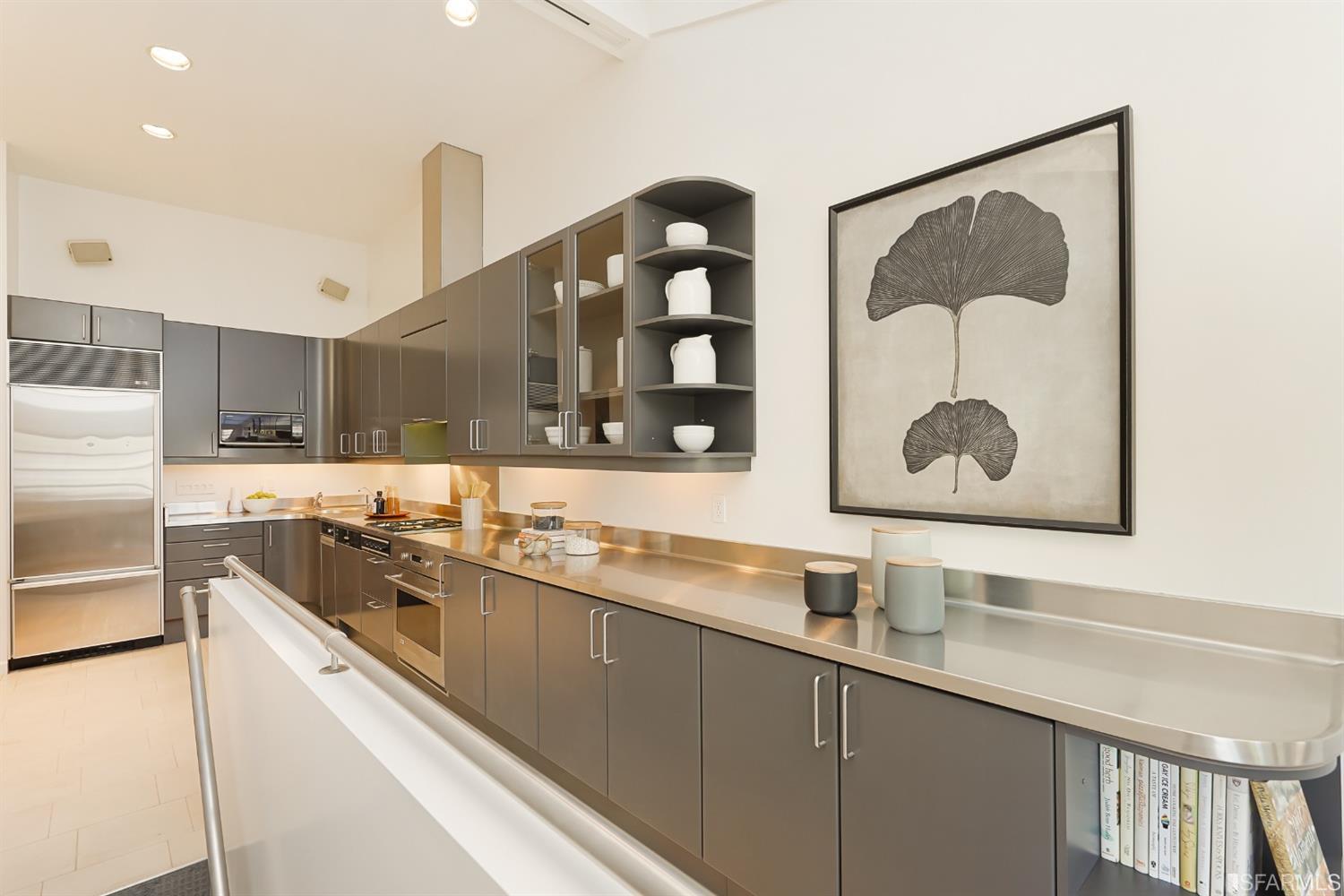 720 Waller Street San Francisco, CA 94117 - Photo 13 of 44 a kitchen with stainless steel appliances a sink a stove and a refrigerator with wooden floor