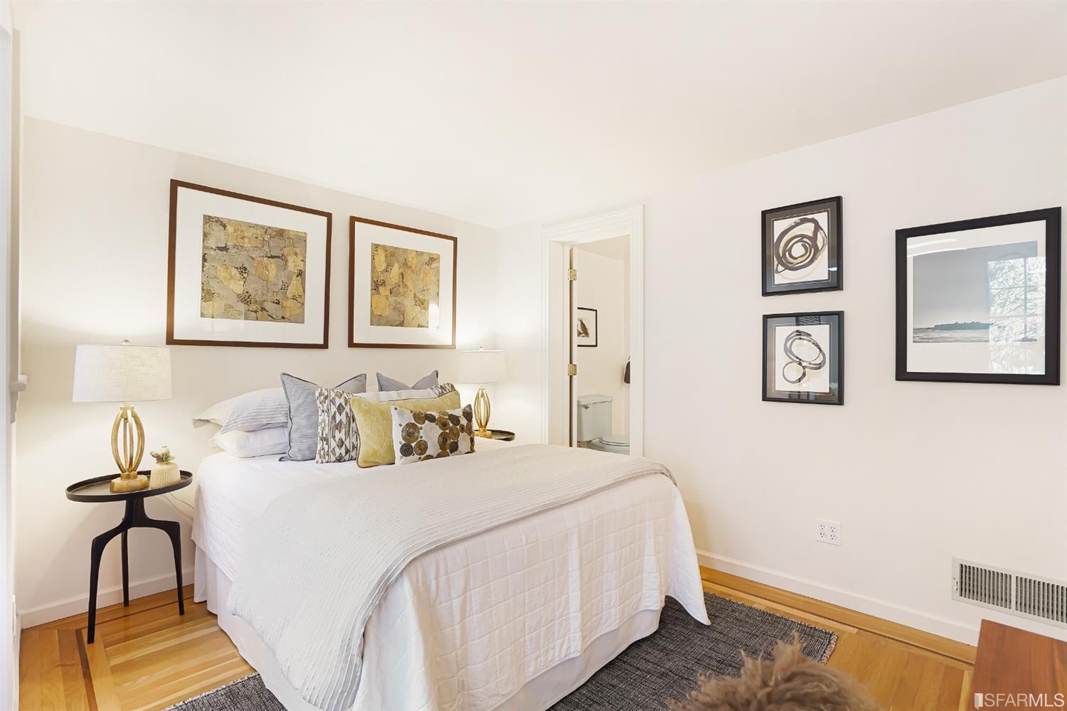 720 Waller Street San Francisco, CA 94117 - Photo 29 of 44 a bedroom with a bed and a painting on the wall