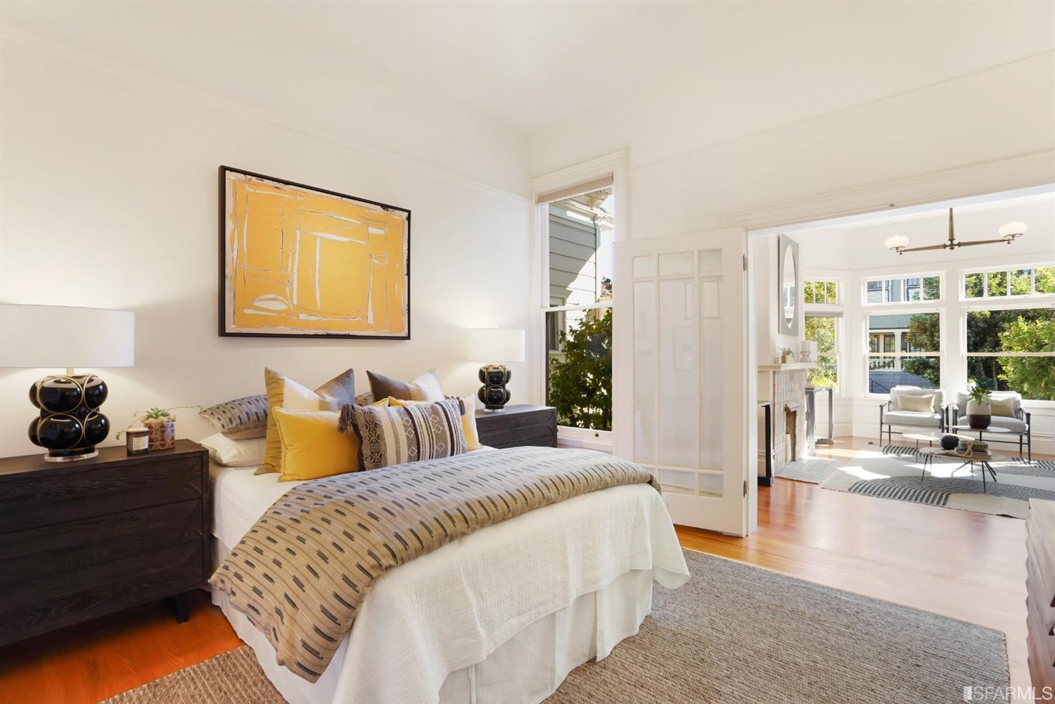 720 Waller Street San Francisco, CA 94117 - Photo 7 of 44 a spacious bedroom with a bed and glass door