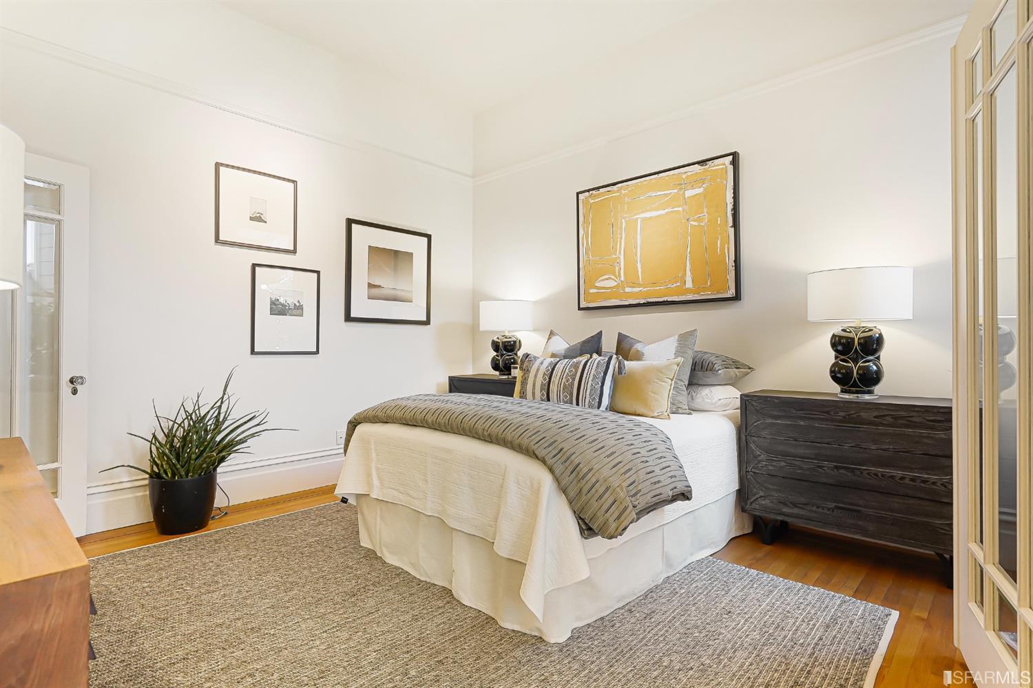 720 Waller Street San Francisco, CA 94117 - Photo 8 of 44 a spacious bedroom with a bed and a couch