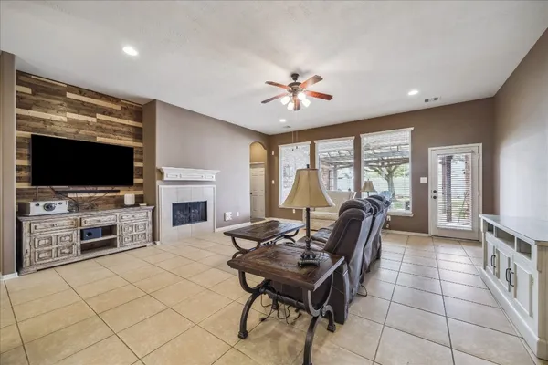 a living room with furniture a flat screen tv and a fireplace