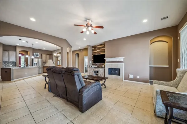 a living room with furniture a fireplace and a flat screen tv