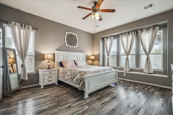 a bedroom with a large bed and a large window