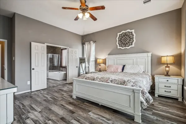 a bedroom with a bed and a chandelier