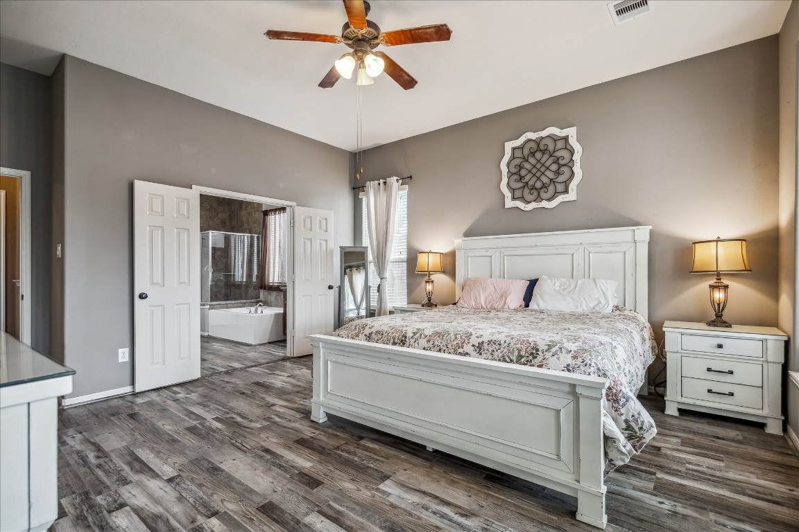 2902 Red Maple Drive Katy, TX 77494 - Photo 20 of 30 a bedroom with a bed and a chandelier