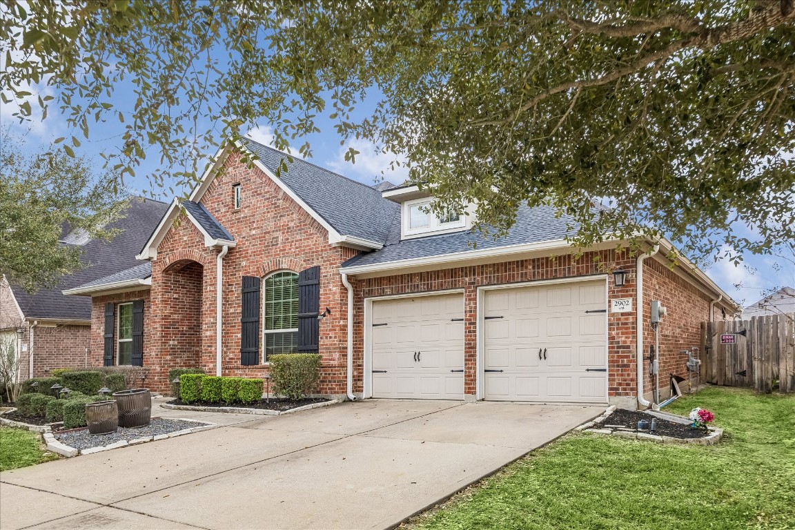 2902 Red Maple Drive Katy, TX 77494 - Photo 2 of 30 a front view of a house with a yard and garage