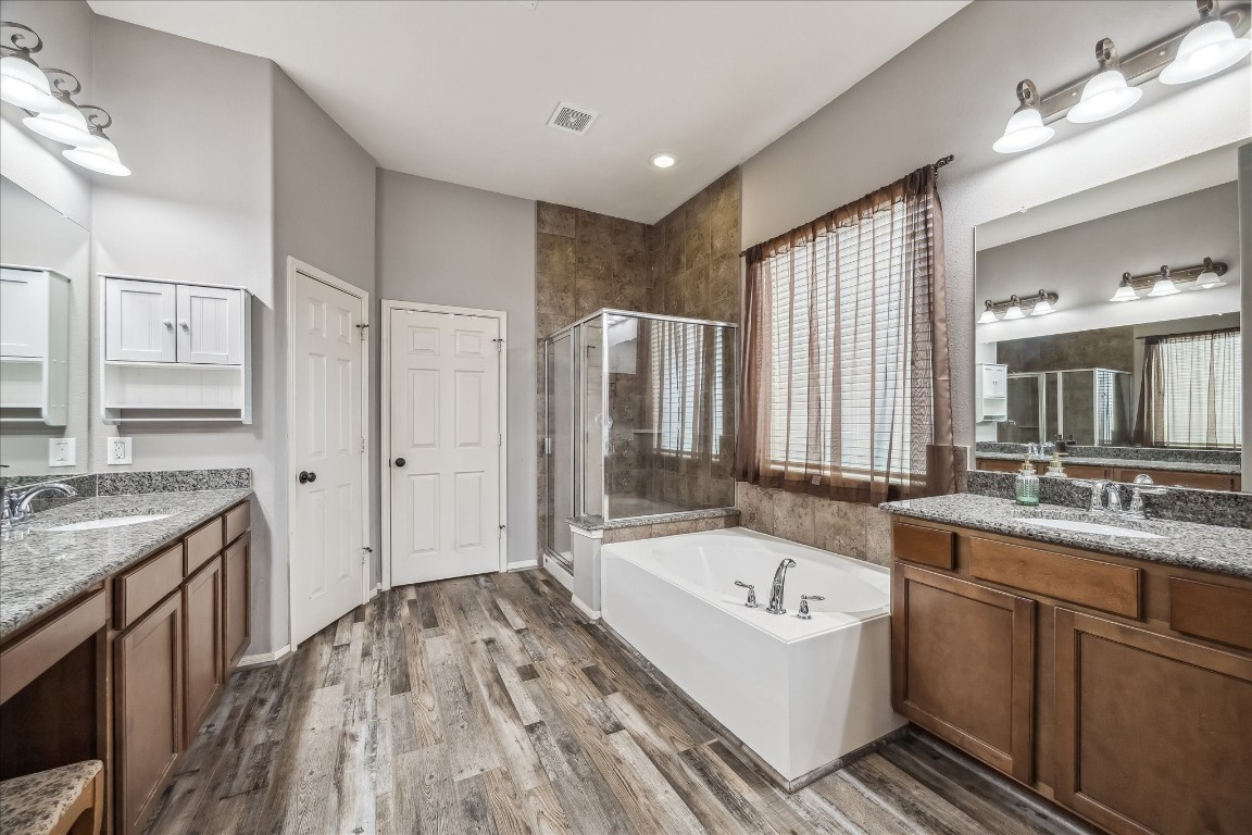 2902 Red Maple Drive Katy, TX 77494 - Photo 21 of 30 a bathroom with a granite countertop tub sink and mirror