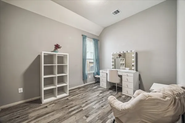 a room with furniture a rug and white walls