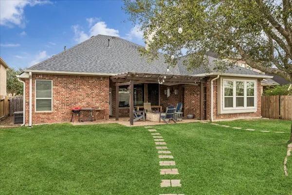 a front view of house with yard and outdoor seating