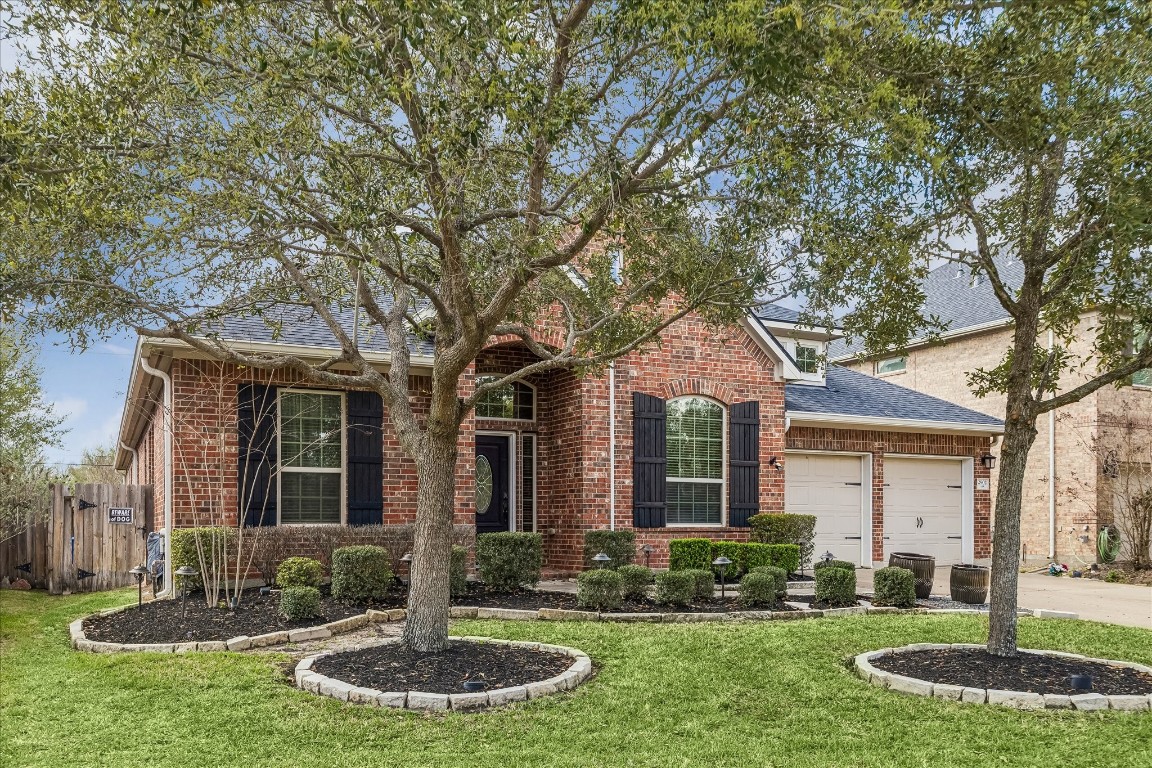 2902 Red Maple Drive Katy, TX 77494 - Photo 3 of 30 a front view of a house with a yard and garage