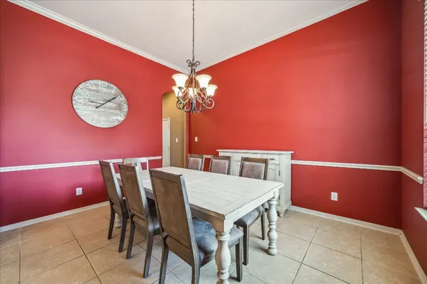 a view of a dining room with furniture and chandelier