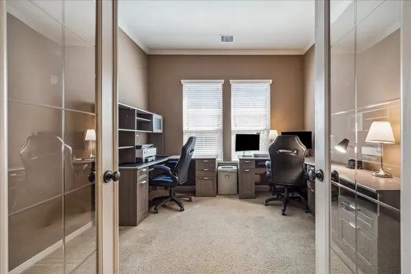 a view of a workspace with furniture and a window
