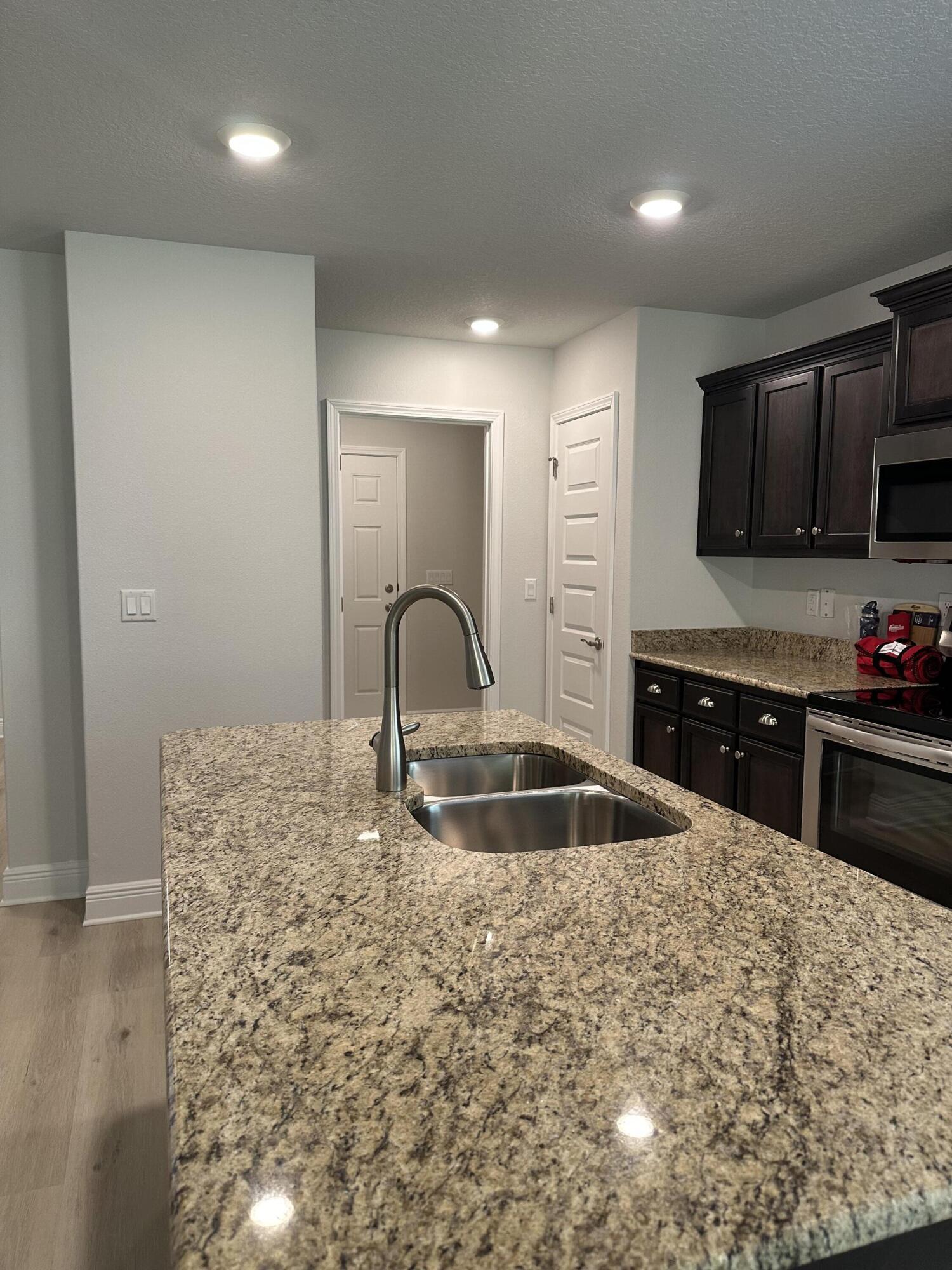 211 Baycliff Drive Crestview, FL 32536 - Photo 13 of 25 a kitchen with granite countertop a stove and a sink