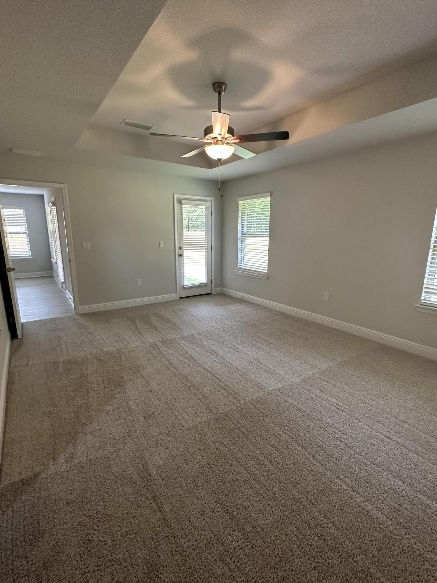 211 Baycliff Drive Crestview, FL 32536 - Photo 19 of 25 an empty room with ceiling fan and window