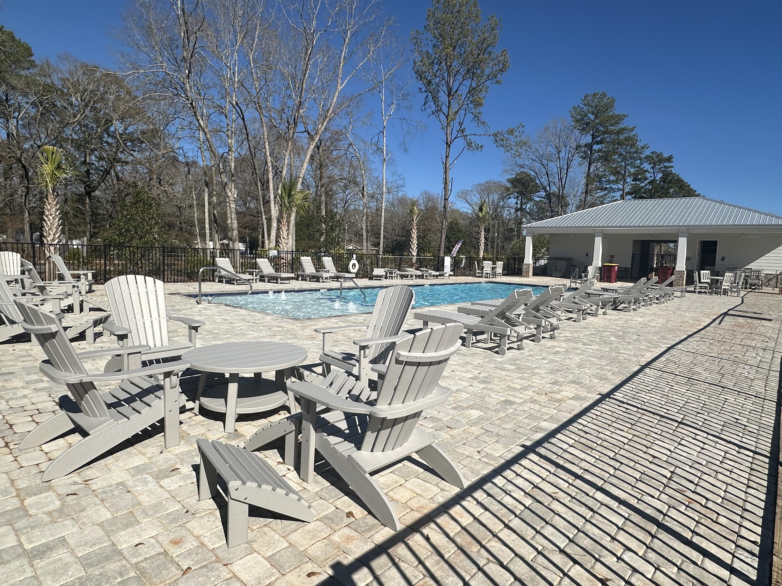 211 Baycliff Drive Crestview, FL 32536 - Photo 24 of 25 a view of a patio with dining table and chairs with wooden floor and fence