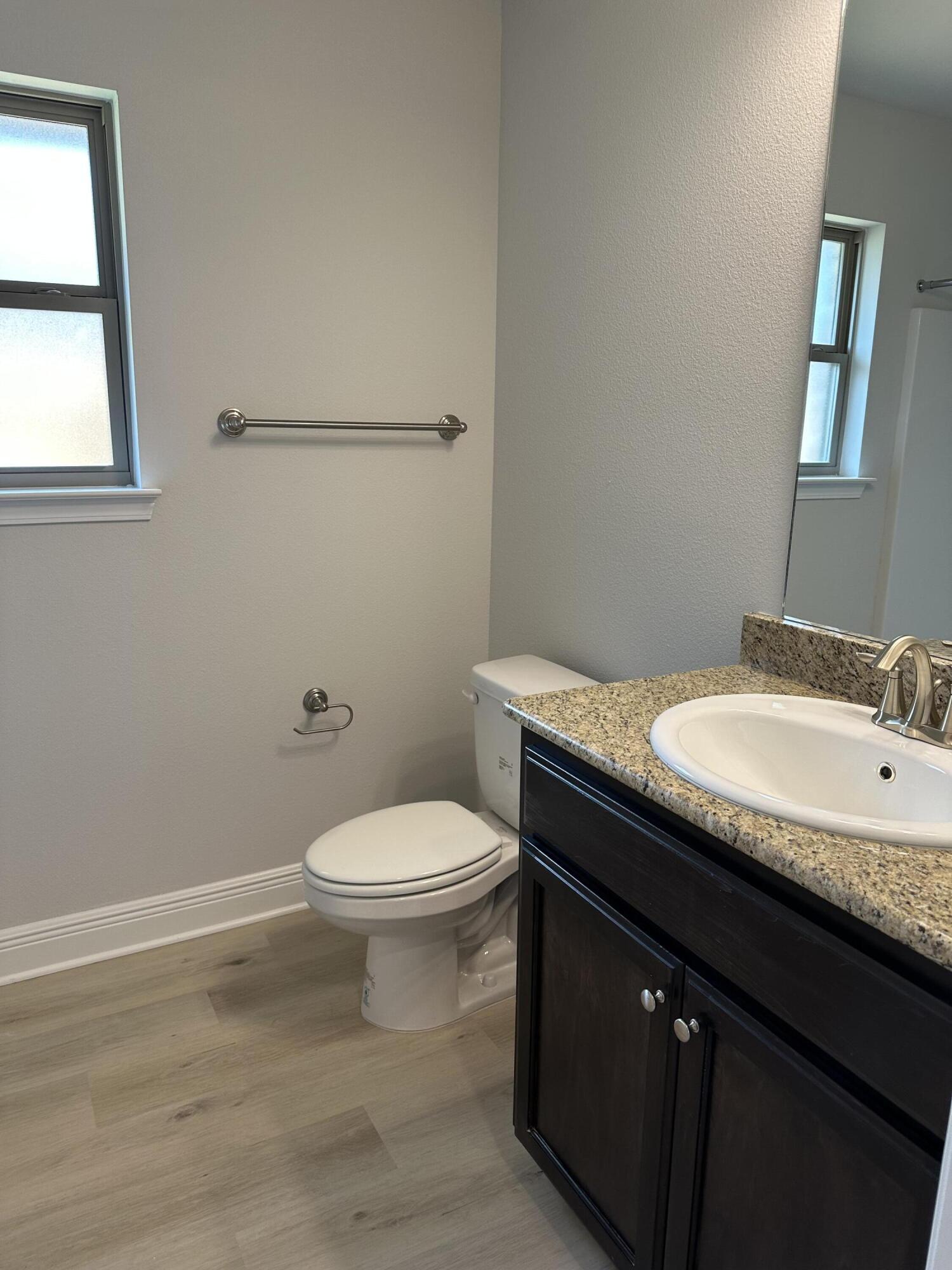 211 Baycliff Drive Crestview, FL 32536 - Photo 9 of 25 a bathroom with a granite countertop sink toilet and mirror