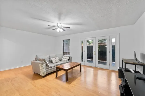 a living room with furniture and wooden floor