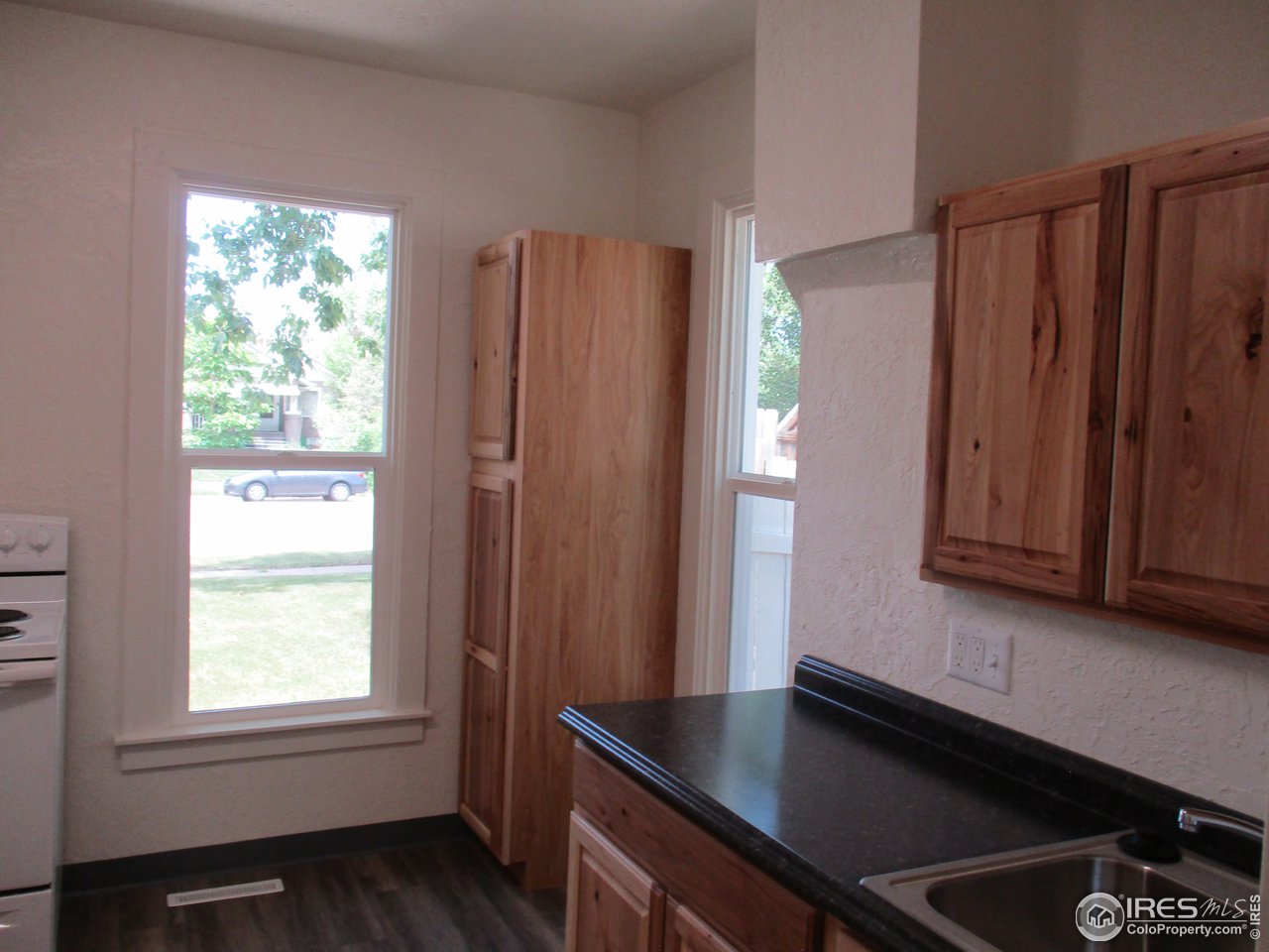 1212 6th Street Greeley, CO 80631 - Photo 9 of 20 a kitchen with windows and refrigerator