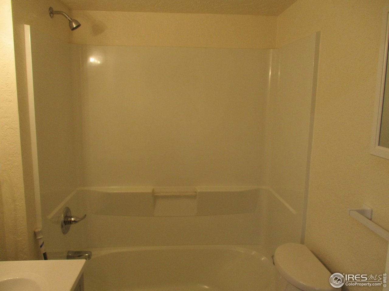 1212 6th Street Greeley, CO 80631 - Photo 10 of 20 a bathroom with a shower and toilet