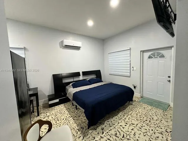 a bedroom with furniture and a window