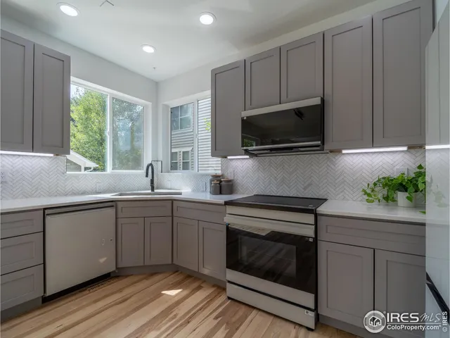 a kitchen with a sink stove and microwave