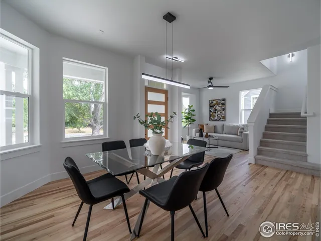 a view of a dining room with furniture wooden floor and chandelier