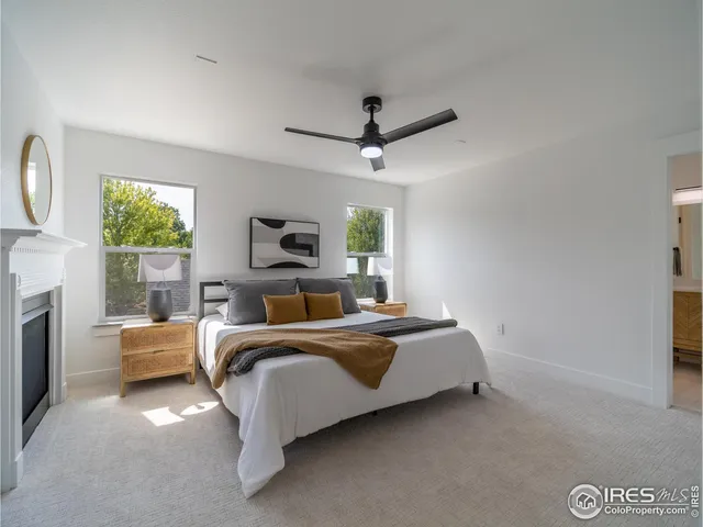 a bed room with a bed mirror and a window