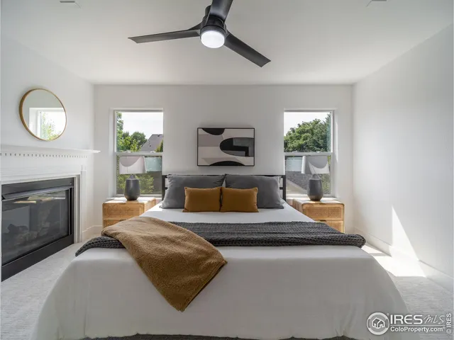 a bedroom with a large bed and a fireplace