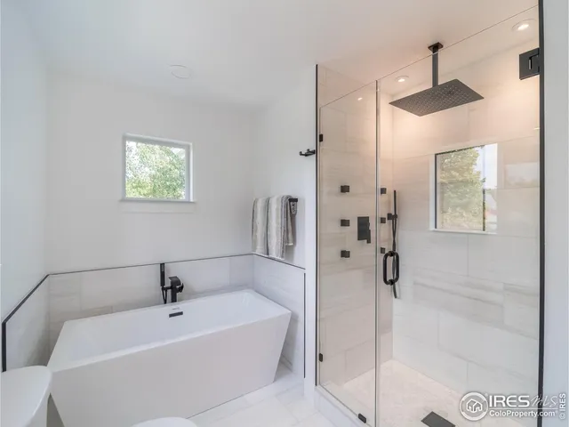 a bathroom with a bathtub and shower