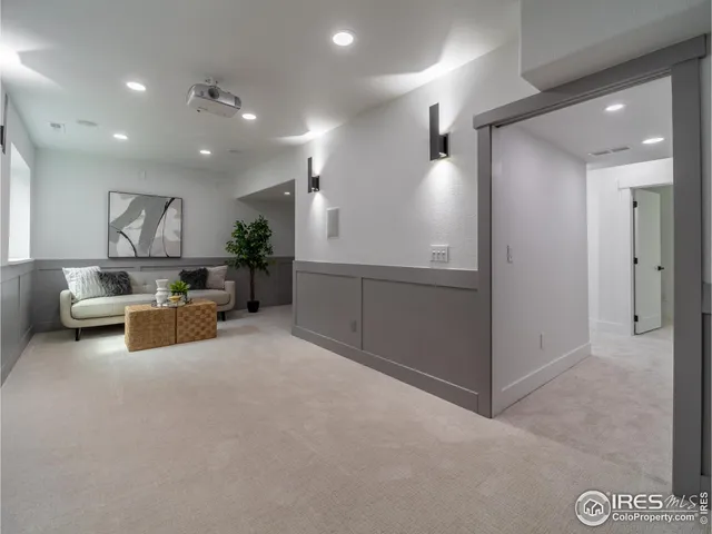 an empty room with furniture and a ceiling fan