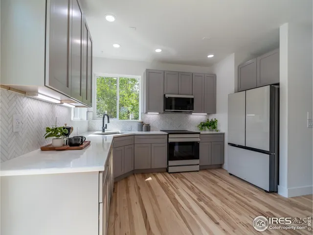 a kitchen with a refrigerator and a sink
