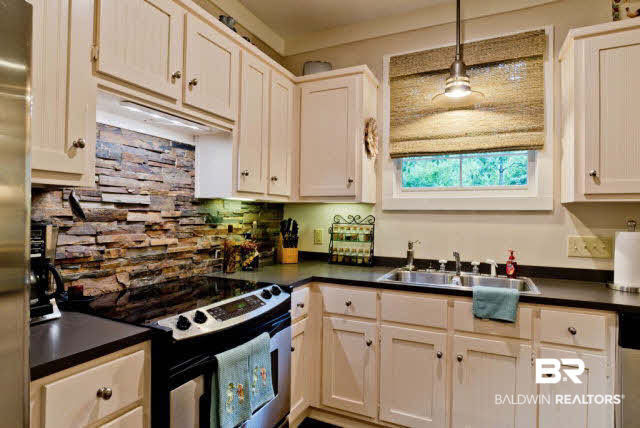 25773 Canal Road, Unit 26 Orange Beach, AL 36561 - Photo 12 of 42 Nice custom cabinets with granite and stone backsplash
