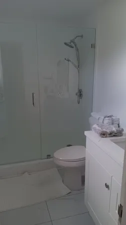 a white toilet sitting next to a bathroom sink