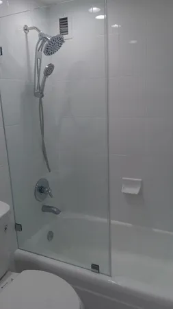 a bathroom with a shower and a bath tub