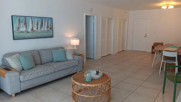 a living room with furniture and a potted plant