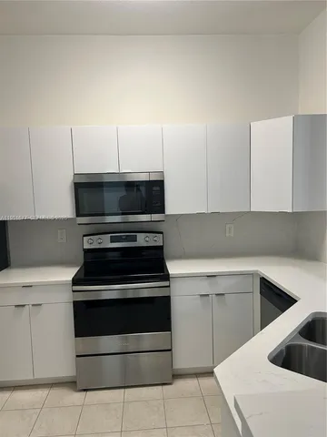 a kitchen with a stove and a sink